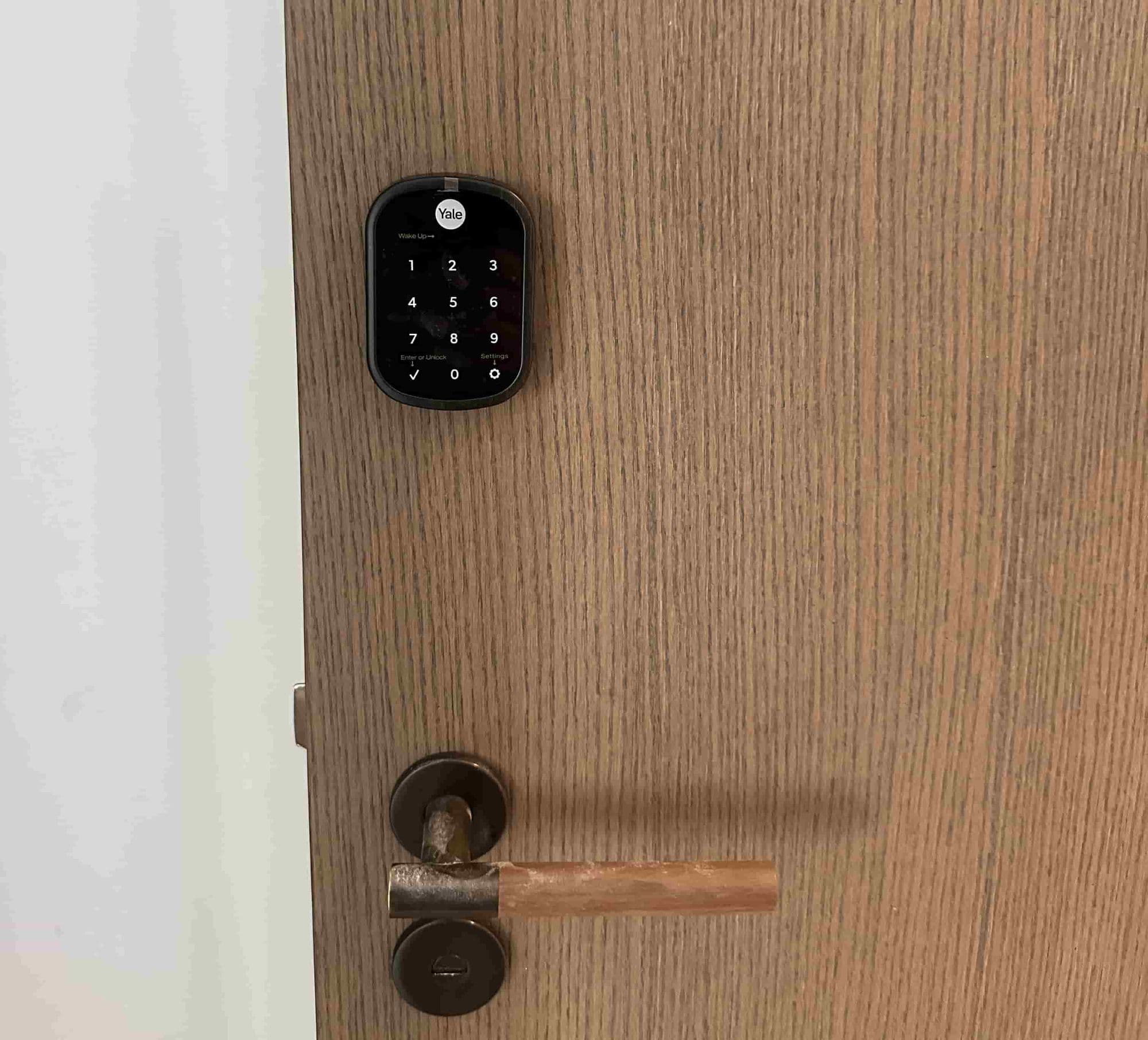 Keypad smart lock and lever installed on a wood apartment door
