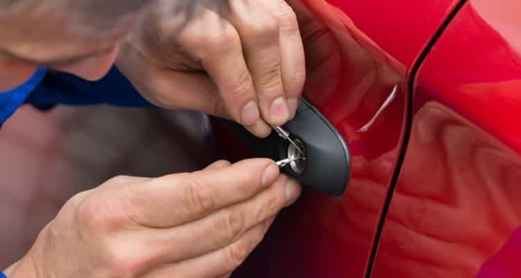Locksmith opening a red car door